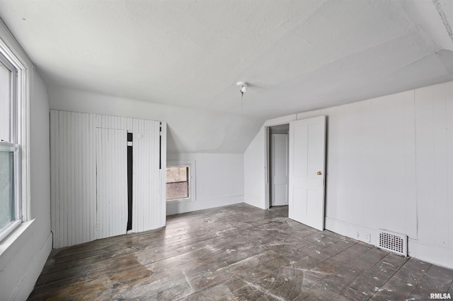 2330 S Airport Rd, Bartonville, IL 61607 - bonus room featuring visible vents, vaulted ceiling, hardwood / wood-style flooring, and a textured ceiling