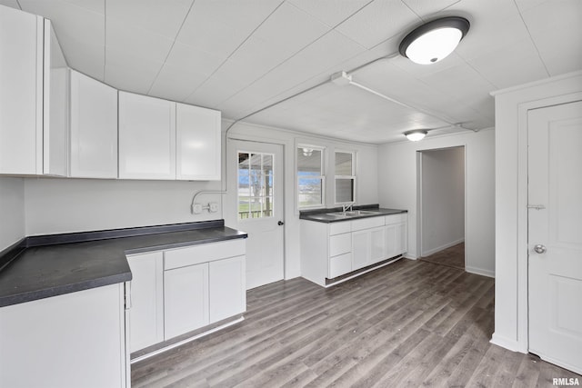 2330 S Airport Rd, Bartonville, IL 61607 - kitchen with a sink, white cabinetry, wood finished floors, and dark countertops