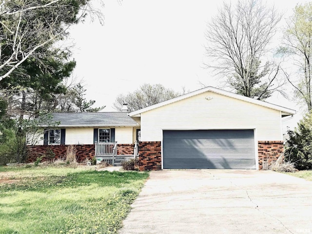 single story home with an attached garage, brick siding, driveway, and a front lawn