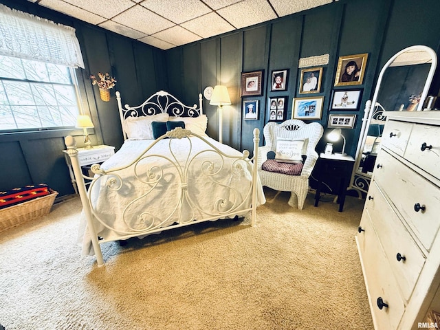 bedroom with carpet and a decorative wall