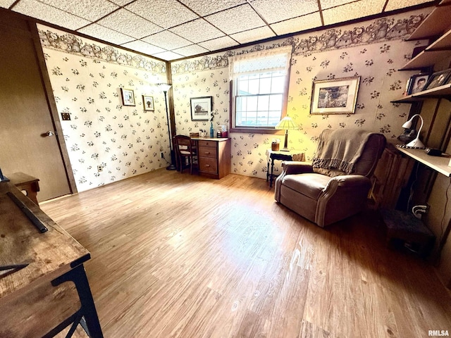 living area featuring wallpapered walls and light wood-type flooring