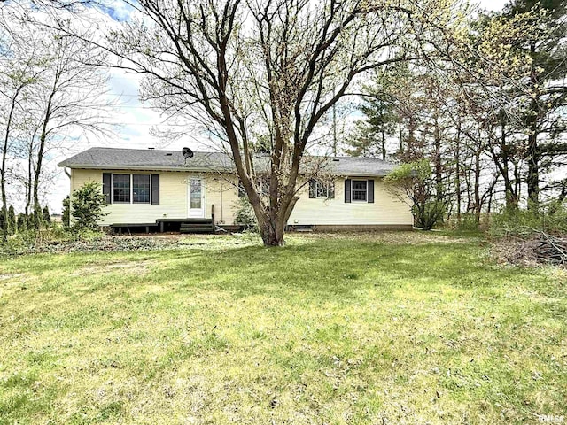 back of property with a lawn