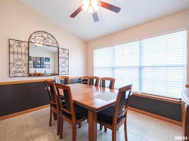 dining room featuring baseboards, a ceiling fan, and lofted ceiling