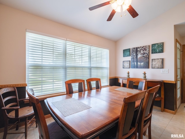 dining space with a healthy amount of sunlight, light tile patterned floors, ceiling fan, and lofted ceiling