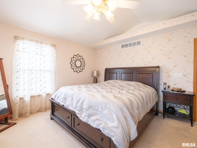 bedroom featuring visible vents, a ceiling fan, light colored carpet, and vaulted ceiling