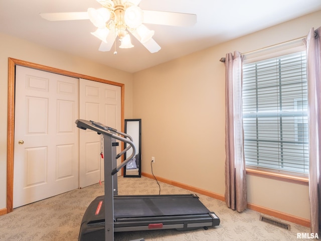 workout room with visible vents, ceiling fan, carpet flooring, and baseboards