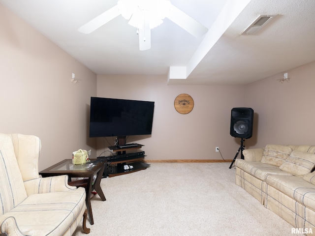 carpeted living area with baseboards, a ceiling fan, and visible vents