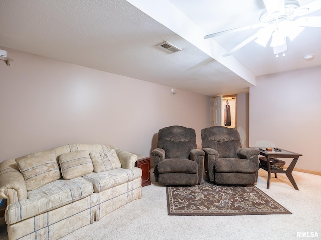 carpeted living area with ceiling fan and visible vents