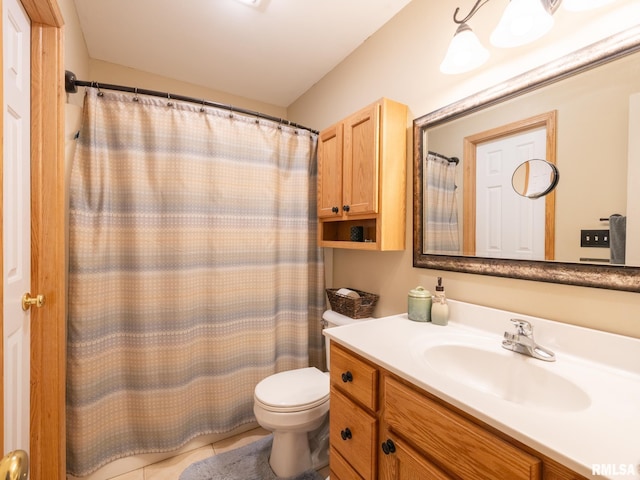 full bath with toilet, vanity, and tile patterned flooring