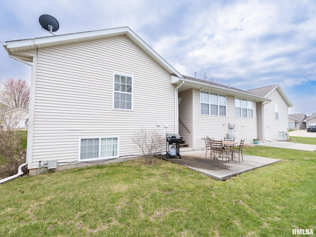 back of house with a patio and a yard