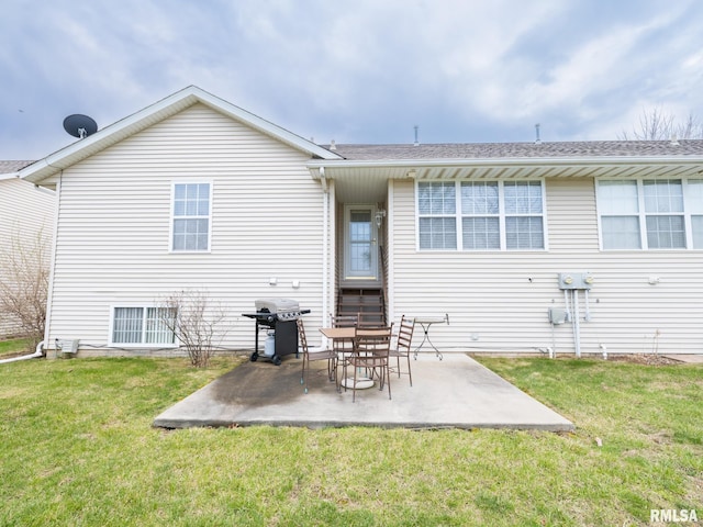 back of property featuring a patio, a yard, and central AC