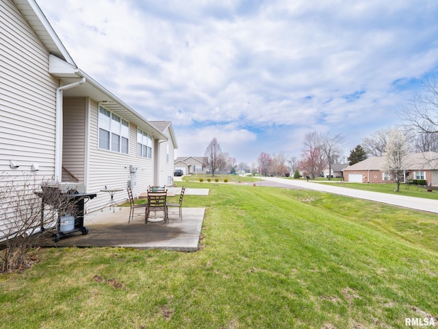 view of yard featuring a patio and a residential view