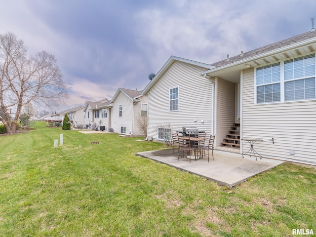 back of house with a patio, a yard, and a residential view