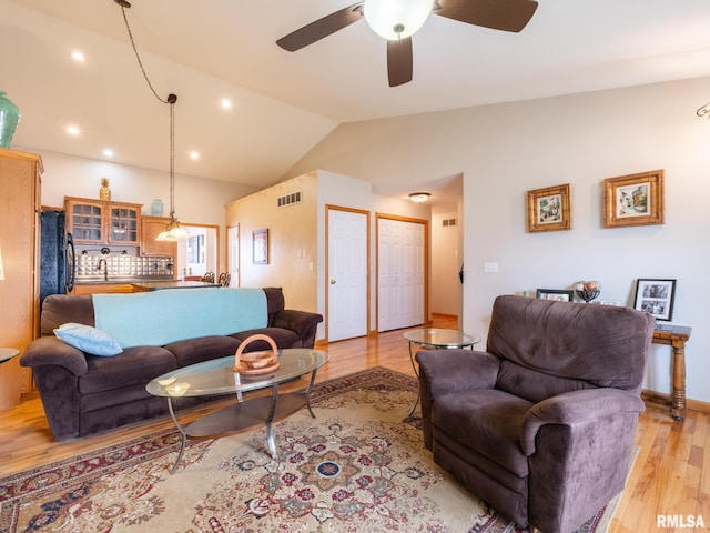 living room with ceiling fan, light wood-style flooring, visible vents, recessed lighting, and lofted ceiling