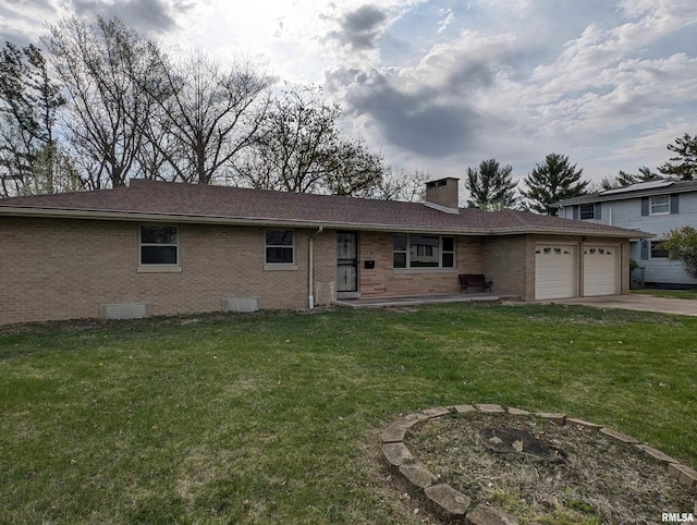 3720 Saint Michael Ave, Peoria, IL 61615 - view of front of house with a chimney, a garage, a front lawn, and brick siding