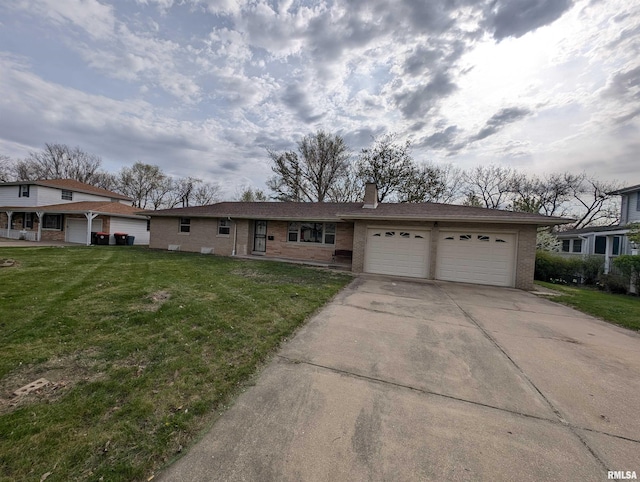 3720 Saint Michael Ave, Peoria, IL 61615 - ranch-style house with a chimney, driveway, a front yard, brick siding, and a garage