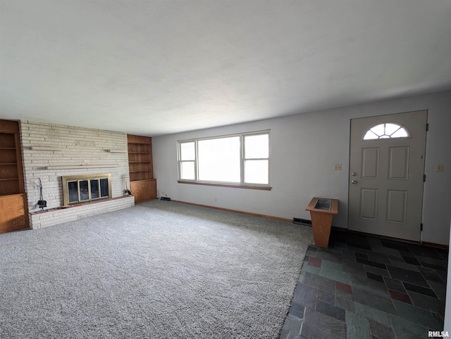 3720 Saint Michael Ave, Peoria, IL 61615 - unfurnished living room featuring a large fireplace, built in features, baseboards, and dark carpet