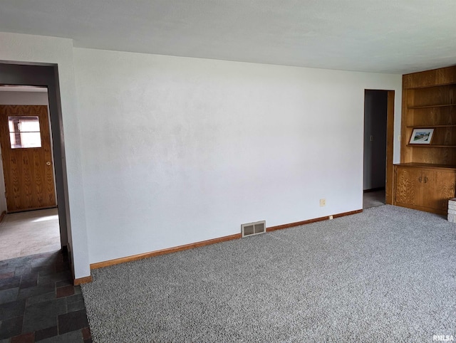 3720 Saint Michael Ave, Peoria, IL 61615 - carpeted empty room featuring built in features, baseboards, and visible vents