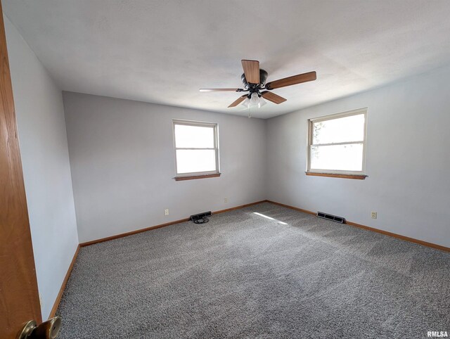 3720 Saint Michael Ave, Peoria, IL 61615 - spare room featuring visible vents, baseboards, a ceiling fan, and carpet flooring