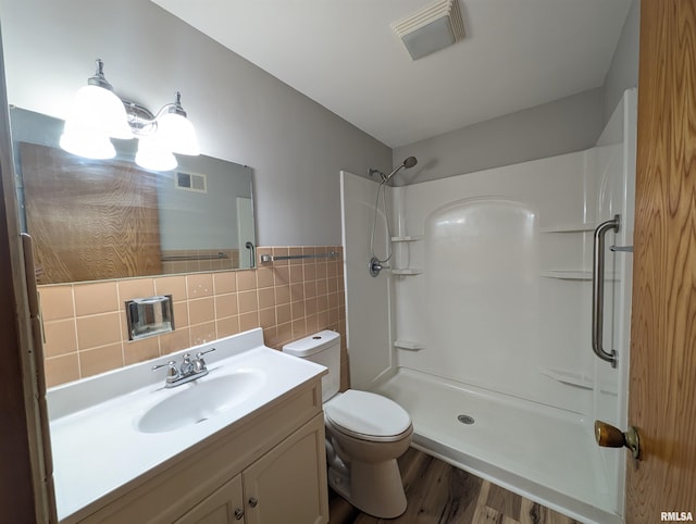 3720 Saint Michael Ave, Peoria, IL 61615 - full bath featuring a shower, wood finished floors, visible vents, and tile walls