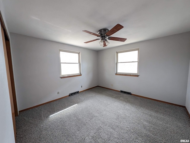3720 Saint Michael Ave, Peoria, IL 61615 - carpeted spare room with visible vents, baseboards, and plenty of natural light