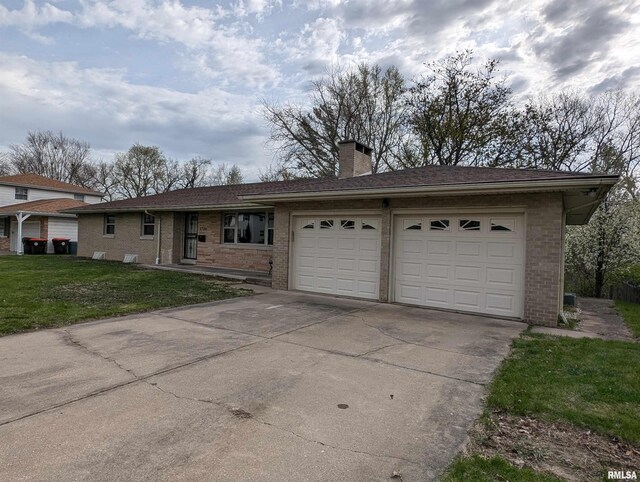 3720 Saint Michael Ave, Peoria, IL 61615 - ranch-style home featuring brick siding, a front yard, a garage, and concrete driveway
