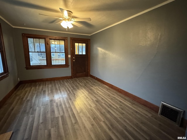 1017 W Brons Ave, Peoria, IL 61604 - foyer featuring crown molding, ceiling fan, visible vents, wood finished floors, and baseboards