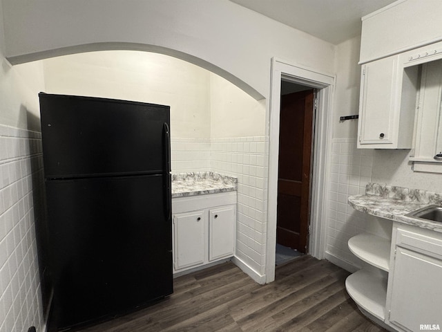 1017 W Brons Ave, Peoria, IL 61604 - kitchen featuring freestanding refrigerator, light countertops, white cabinetry, and tile walls