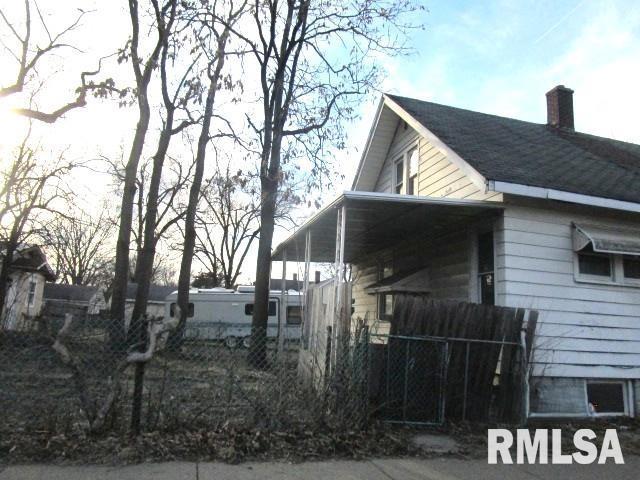 2502 W Malone St, Peoria, IL 61605 - view of side of property with a chimney and fence