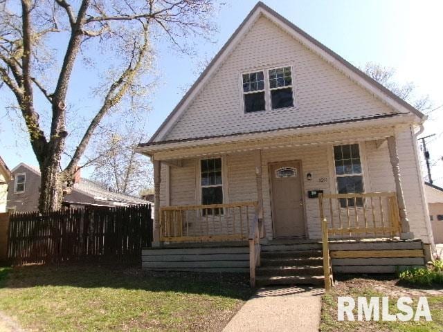 bungalow-style house featuring a porch and fence