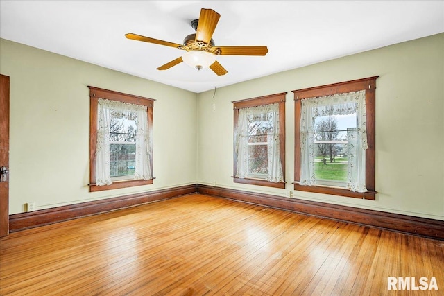 spare room featuring a wealth of natural light, ceiling fan, hardwood / wood-style floors, and a baseboard heating unit