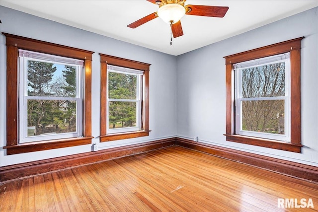 unfurnished room with baseboards and wood finished floors