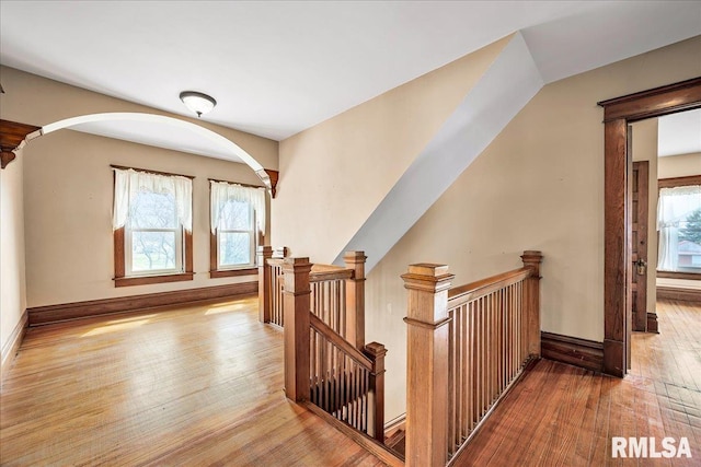 bonus room with baseboards and hardwood / wood-style floors