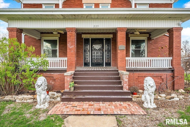 entrance to property featuring brick siding and covered porch