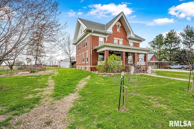 view of front facade featuring a porch, a front lawn, and brick siding