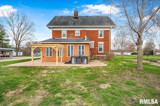 back of house with a patio, a chimney, a pergola, a hot tub, and a lawn