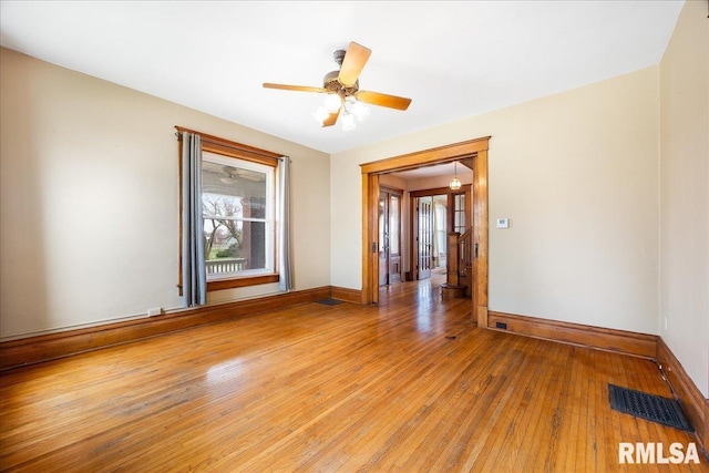 spare room featuring visible vents, baseboards, plenty of natural light, and light wood-style floors