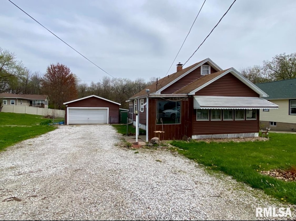 view of front of property with an outbuilding, a garage, and a chimney