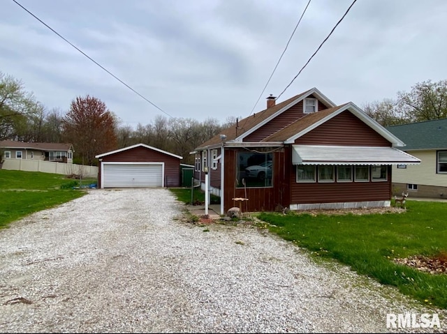 view of front of property with an outbuilding, a garage, and a chimney