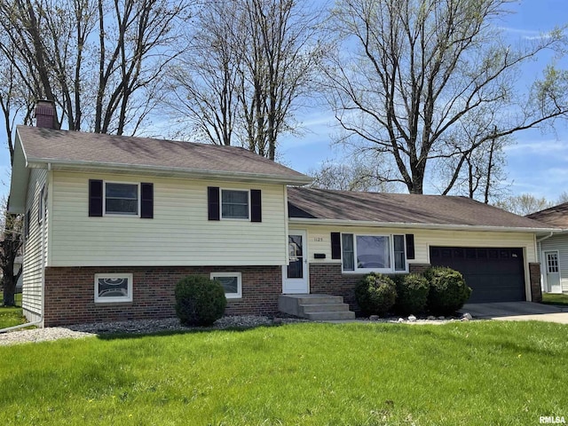 tri-level home featuring a front yard, an attached garage, driveway, and a chimney
