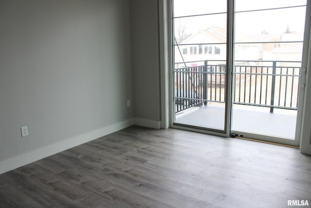 1310 E Samuel Ave, Peoria Heights, IL 61616 - unfurnished room featuring a wealth of natural light, wood finished floors, and baseboards