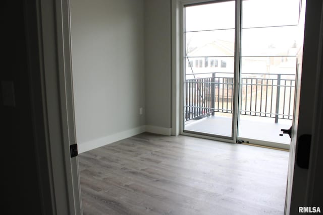 1310 E Samuel Ave, Peoria Heights, IL 61616 - spare room featuring baseboards, wood finished floors, and a healthy amount of sunlight
