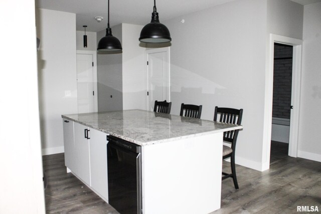 1310 E Samuel Ave, Peoria Heights, IL 61616 - kitchen with a breakfast bar, baseboards, white cabinets, dark wood-type flooring, and hanging light fixtures