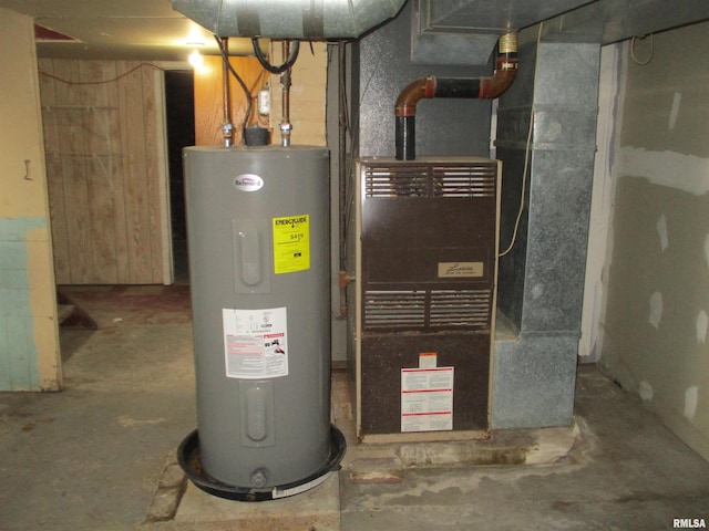 utility room with heating unit and electric water heater