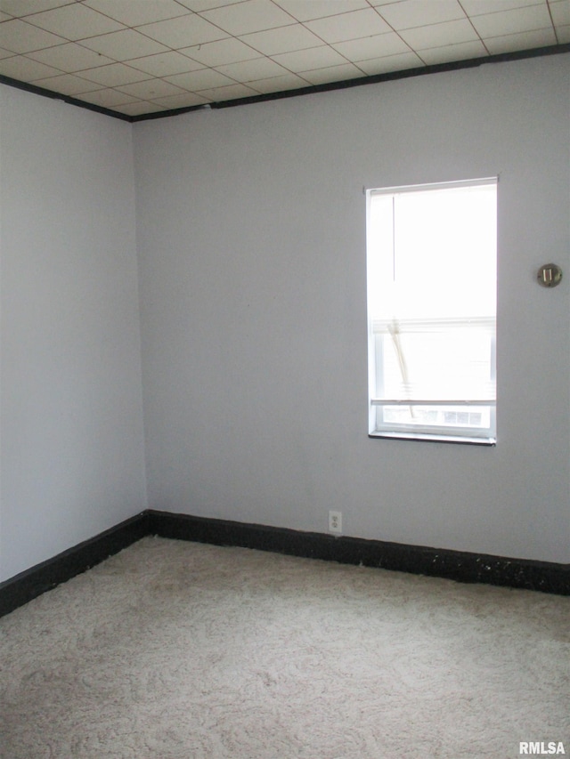 spare room featuring baseboards and carpet
