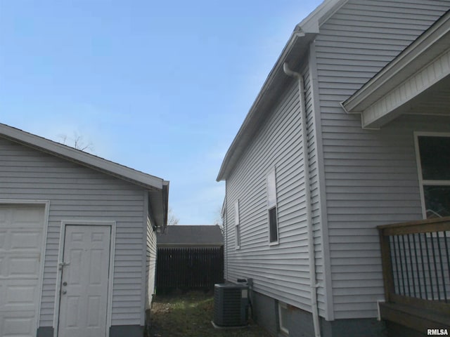 view of home's exterior featuring a garage and central AC unit