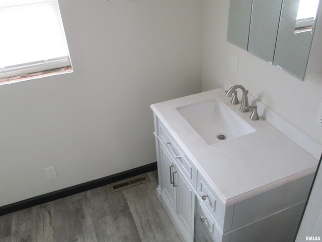 bathroom featuring vanity, wood finished floors, and visible vents