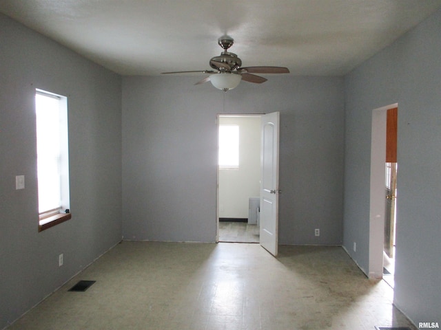 unfurnished room featuring visible vents and a ceiling fan