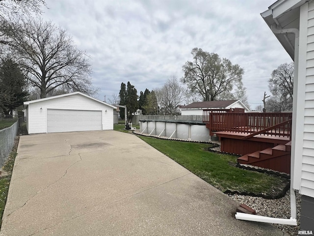 1837 Baird Ave, Galesburg, IL 61401 - view of yard with a deck, an outdoor structure, fence, a garage, and a covered pool