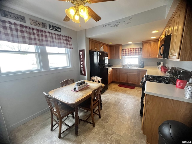 1837 Baird Ave, Galesburg, IL 61401 - kitchen with a sink, ceiling fan, brown cabinetry, light countertops, and black appliances